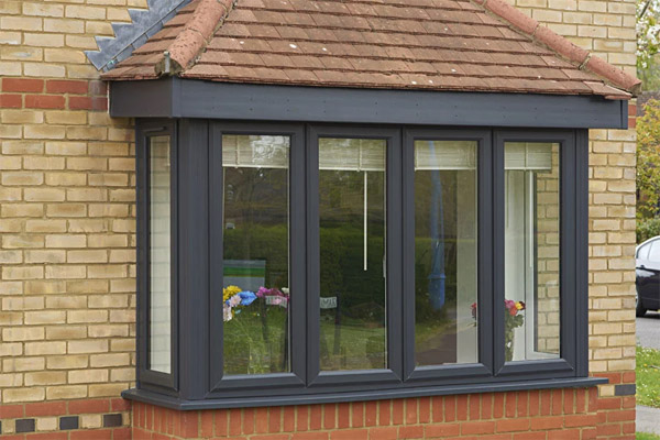 Anthracite grey living room bay window with white internal colour and furniture