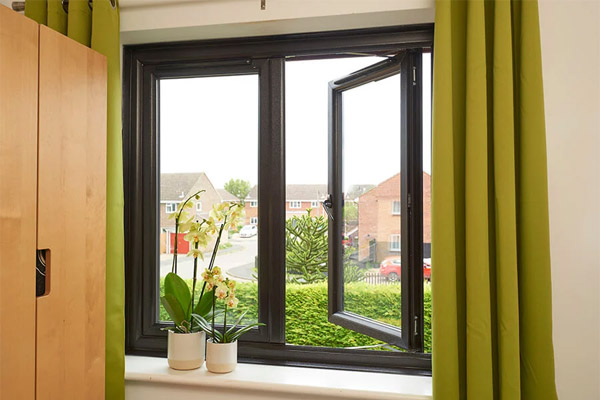 Black bedroom french window with right window open and plants