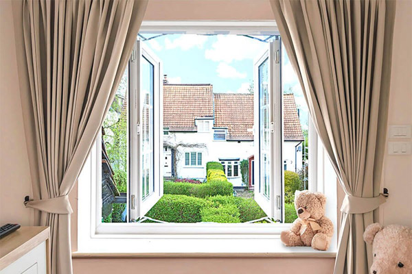 White bedroom french windows with both windows open and cute teddy